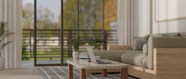 A laptop on a coffee table in a modern and comfortable apartment living room