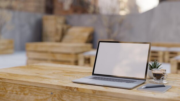 Laptop computer and copy space on wooden table over blurred\
minimal stylish coffee shop