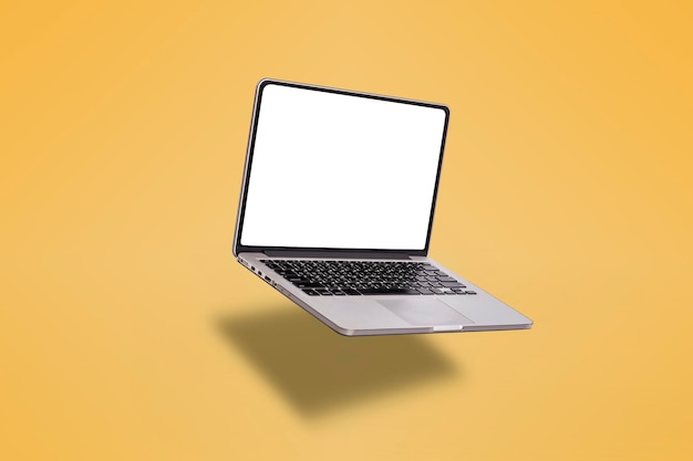 Photo laptop computer or notebook computer with blank screen isolated on yellow background