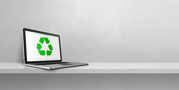 Laptop computer on a shelf with a recycling symbol on screen environmental conservation concept