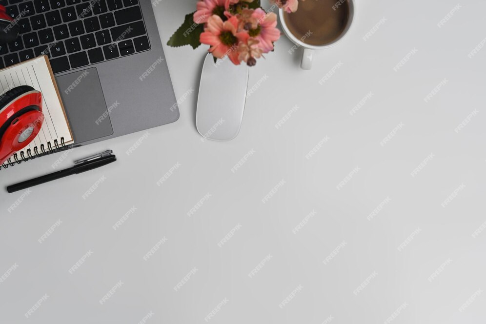 Laptop computer wireless headphone notepad and coffee cup on white office desk top view with copy space