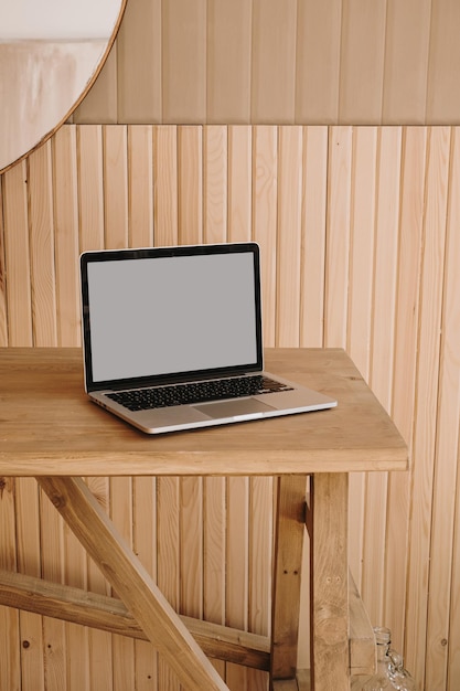 Laptop computer with blank copy space screen on wooden table Minimal aesthetic modern interior design template with mockup copy space