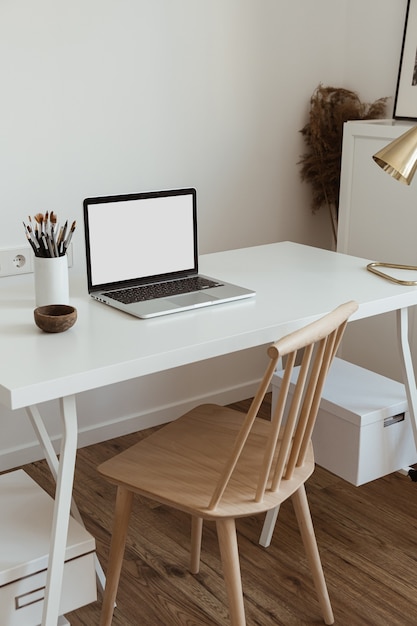 Laptop computer with blank screen on table