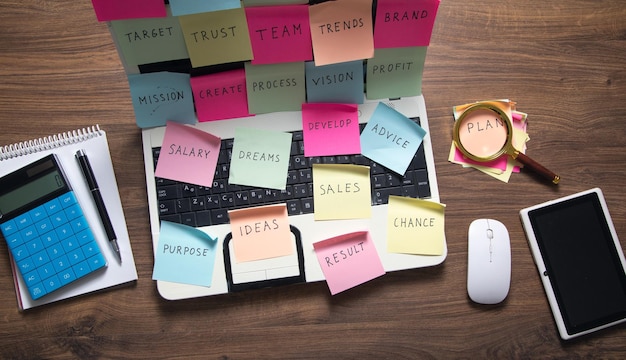 Laptop computer with colorful sticky notes Business