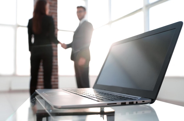 Laptop on the desk background handshake