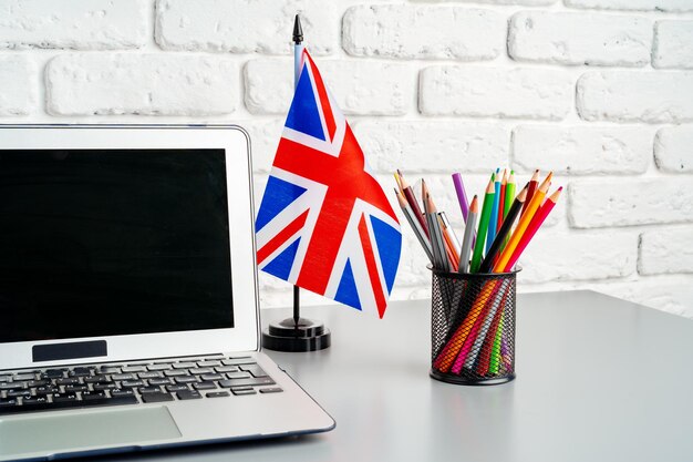 Laptop and flag of uk on desk english language learning concept