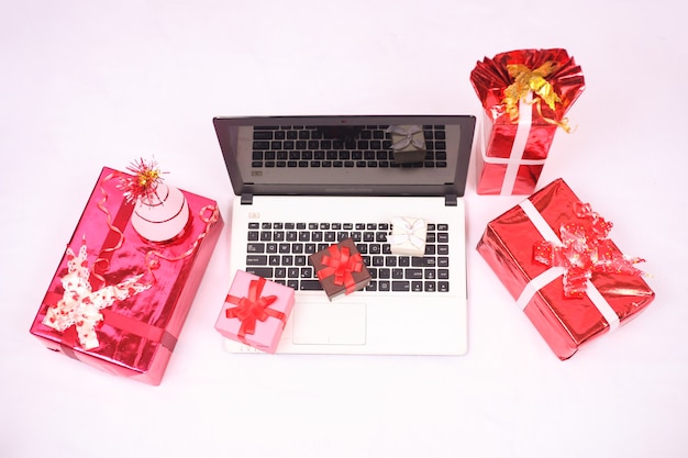 Laptop and gifts for christmas and new year celebration isolated on white background