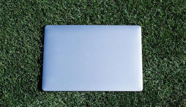 Laptop on green grass agile business distance learning concept always available online