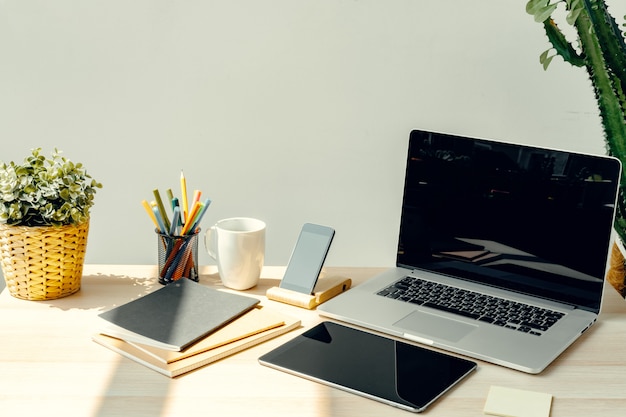 Laptop in een lichte kamer op werktafel met kantoorbenodigdheden