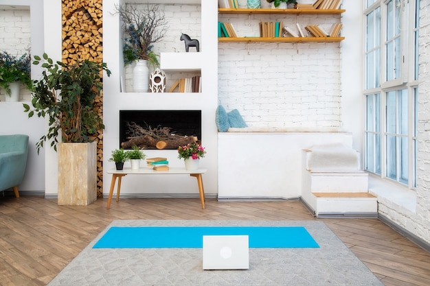 laptop is on the floor in a bright scandinavian-style living room with white coffee table