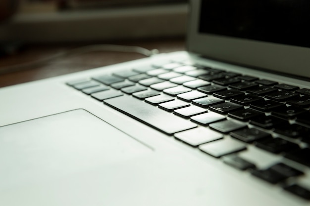 Laptop keyboard in hard daylight. Close-up.