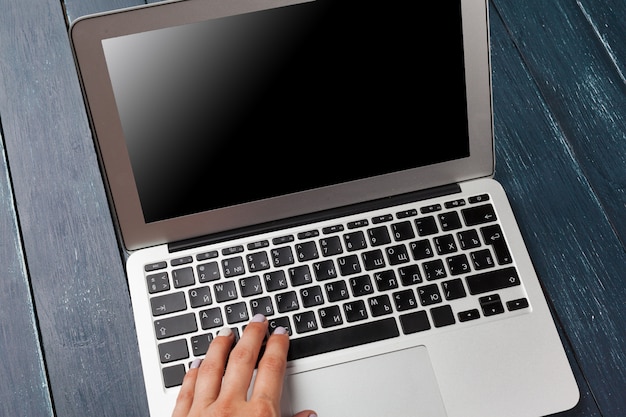 Laptop keyboard on the wooden desk