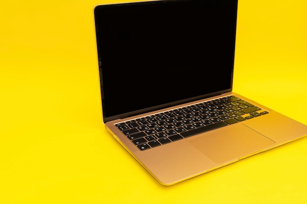 Laptop lies on a golden background