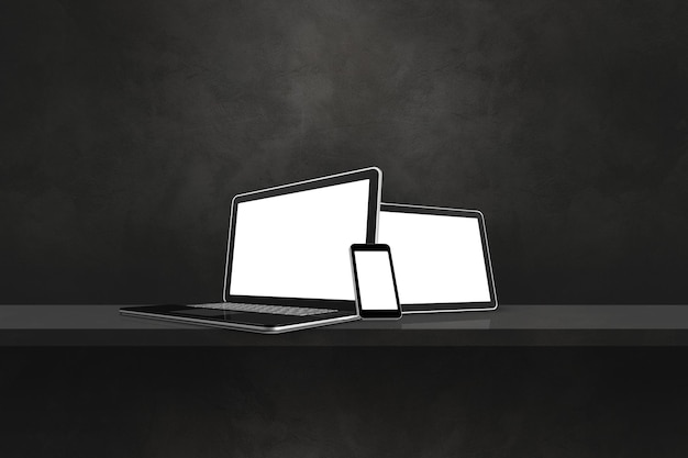 Laptop mobile phone and digital tablet pc on black wall shelf Horizontal background