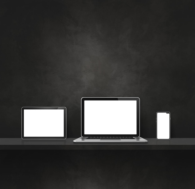 Laptop mobile phone and digital tablet pc on black wall shelf Square background