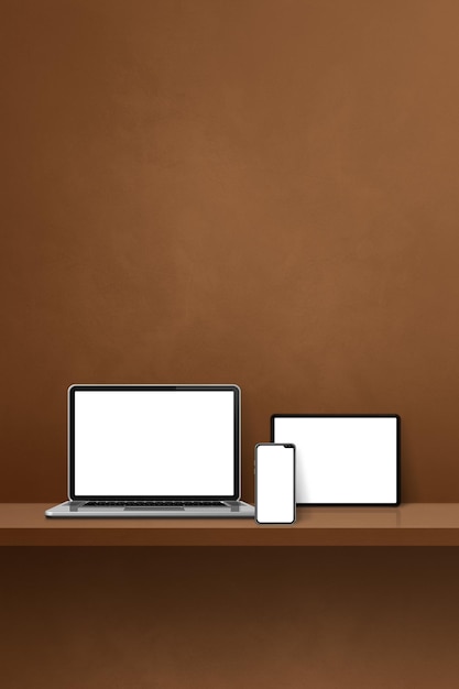 Laptop mobile phone and digital tablet pc on brown wall shelf Vertical background