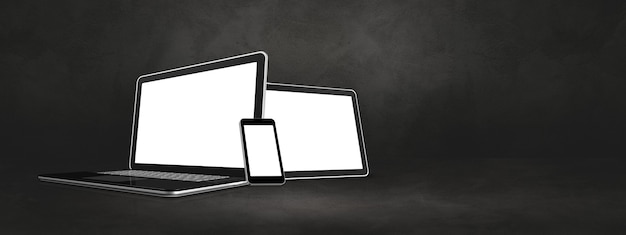 Laptop mobile phone and digital tablet pc on dark concrete