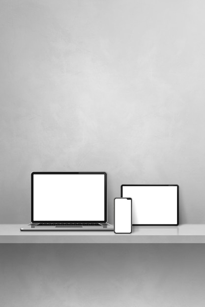 Photo laptop, mobile phone and digital tablet pc on grey wall shelf. vertical background. 3d illustration