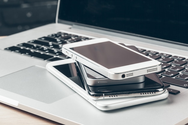 Laptop and mobile phone on the table, Workspace concept,