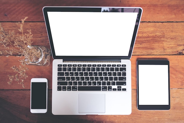 Photo laptop and mobile phone with digital tablet on table