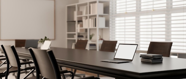 A laptop mockup on a meeting table in modern minimal meeting room