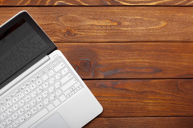 Laptop, notebook on work wooden desk 