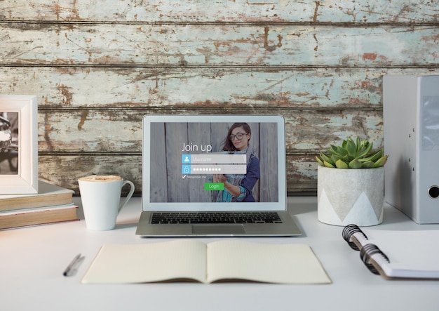 Laptop op een wit bureau met houten muur Inlogscherm