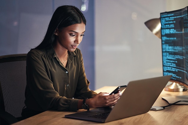 Laptop phone and business woman on coding software development and programming script for cybersecurity Night mobile research and multimedia programmer or IT person on computer with data analysis