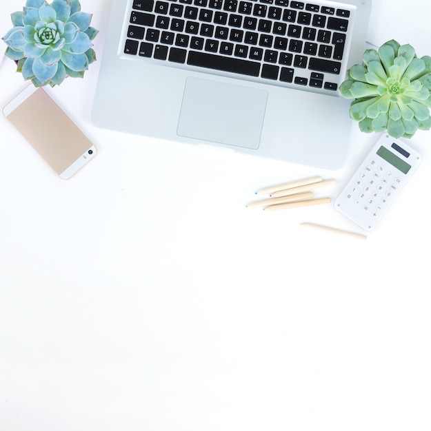 Laptop and phone on white table