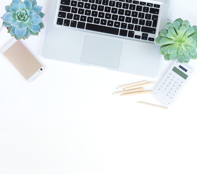 Laptop and phone on white table