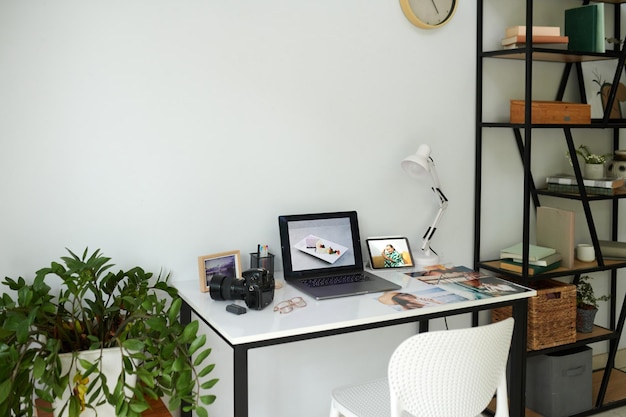 Photo laptop and photos on desk of photographer