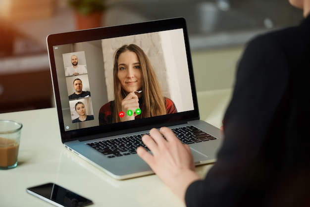 A laptop screen view over a woman's shoulder.