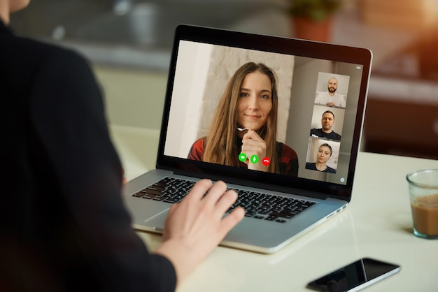 A laptop screen view over a woman's shoulder.