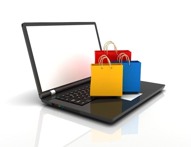 Laptop and shopping pags on white background