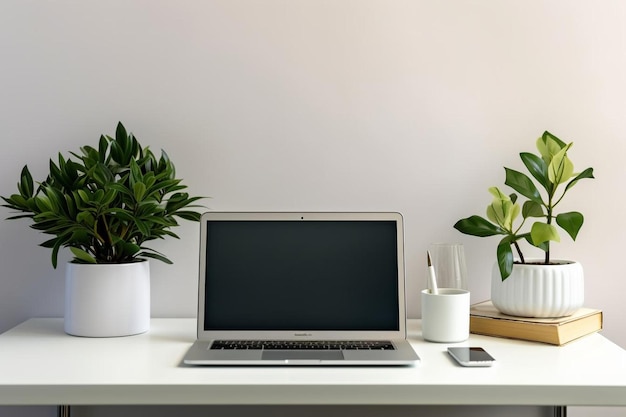 a laptop sits on a desk with a plant and a candle.