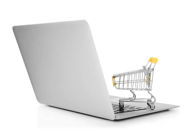 laptop and small shopping cart on white background internet shopping concept