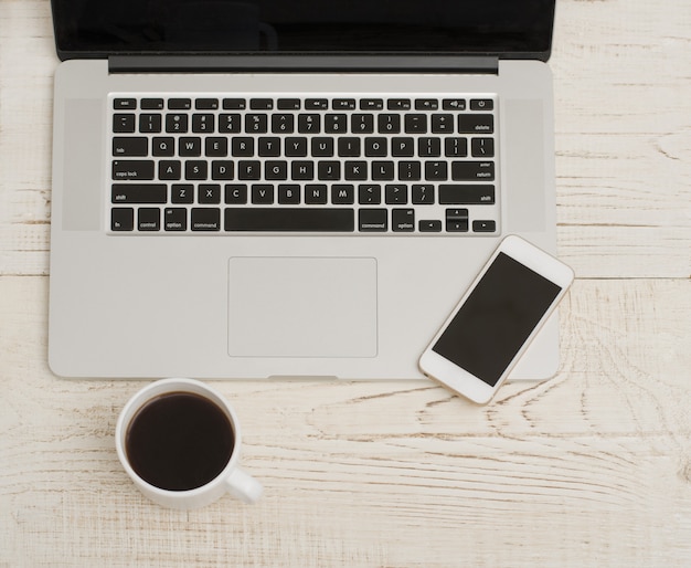 Laptop, smartphone and mug of coffee