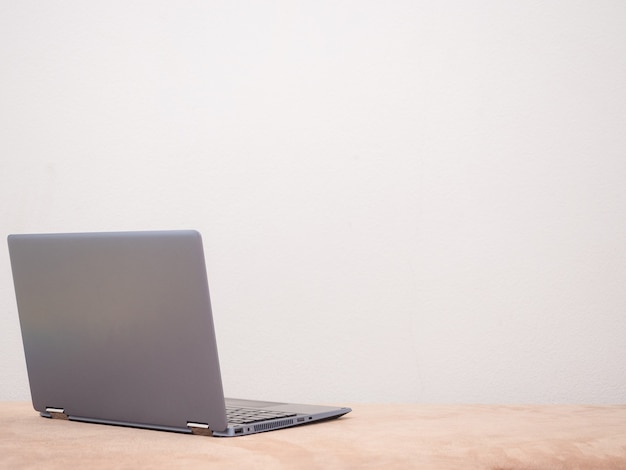 Laptop on sofa silver color on white background copy space concept