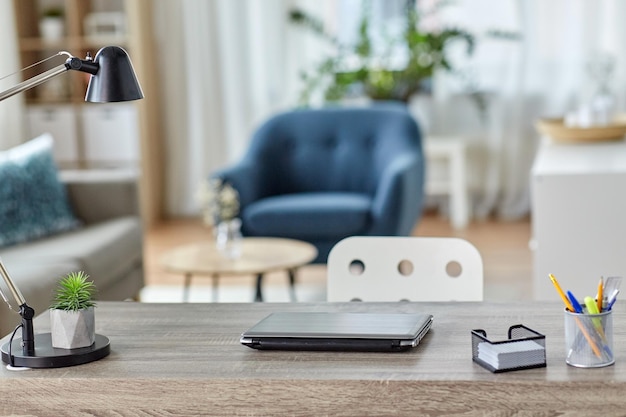 laptop and stationary on table at home office