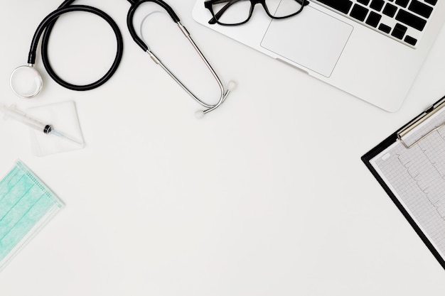 Photo laptop and stethoscope on table