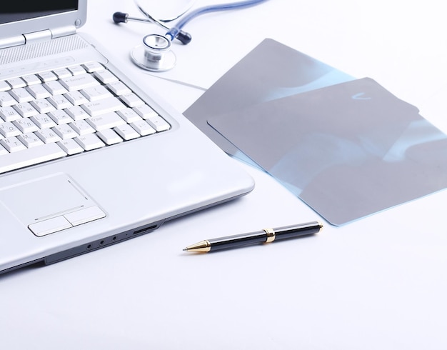 Laptop stethoscope and xray on the table