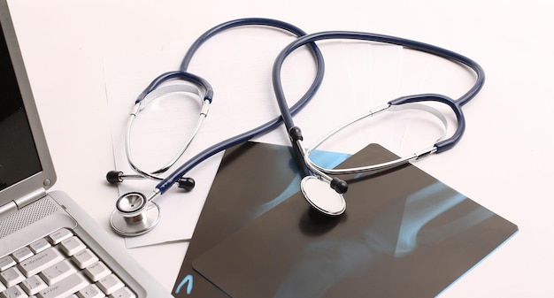 Laptop stethoscope and xray on the table