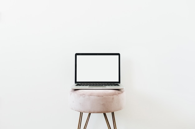 Laptop on stool. Copy space mockup template on white