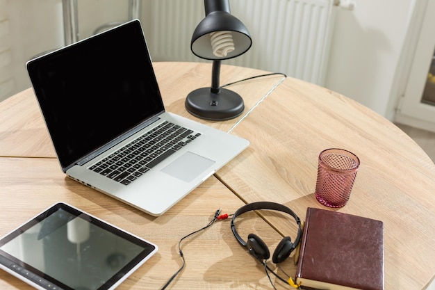 Laptop on table, home interior.