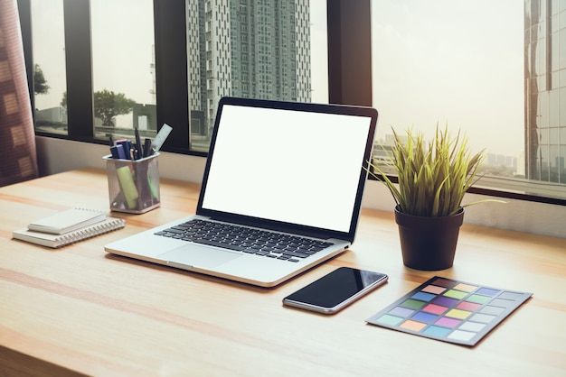 Laptop on table in office room background, for graphics display montage.