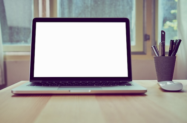 Laptop on table in office room