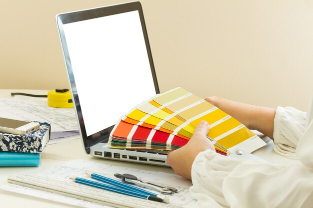 A laptop on the table with colour charts