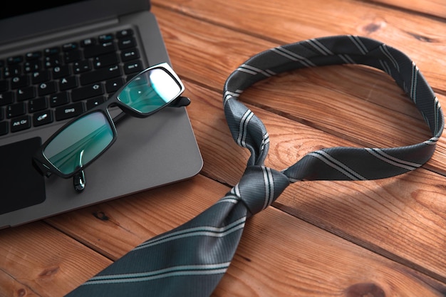 Laptop and tie on the table