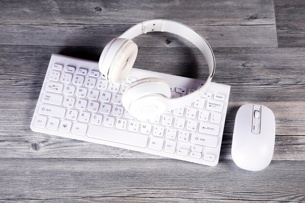 Laptop and white headphones on the table