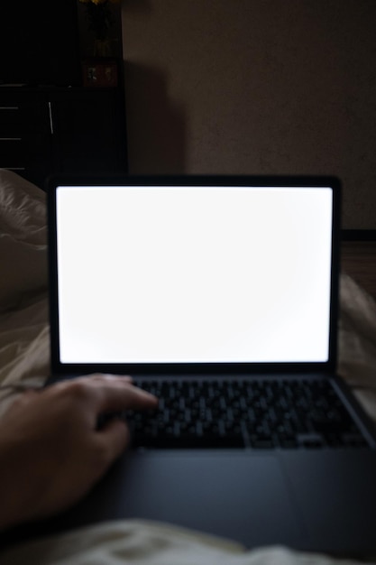 Laptop white screen working in bed copy space point of view